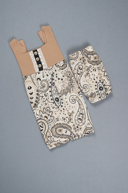 Paisley-patterned fabric with cardboard on a gray background