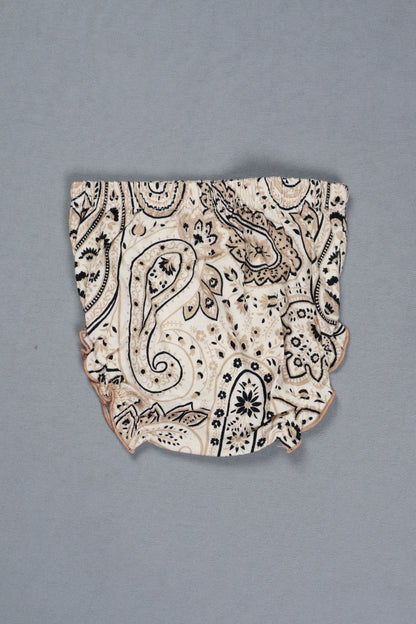 Decorative ceramic shard with black patterns on a gray background