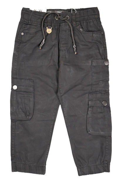 A pair of children's utility cargo pants in a sleek solid black. The pants feature a comfortable elastic waistband with a matching black drawstring, standard side pockets, and multiple large cargo pockets on the legs with secure button-flap closures. They are shown as a flat lay against a neutral background.
